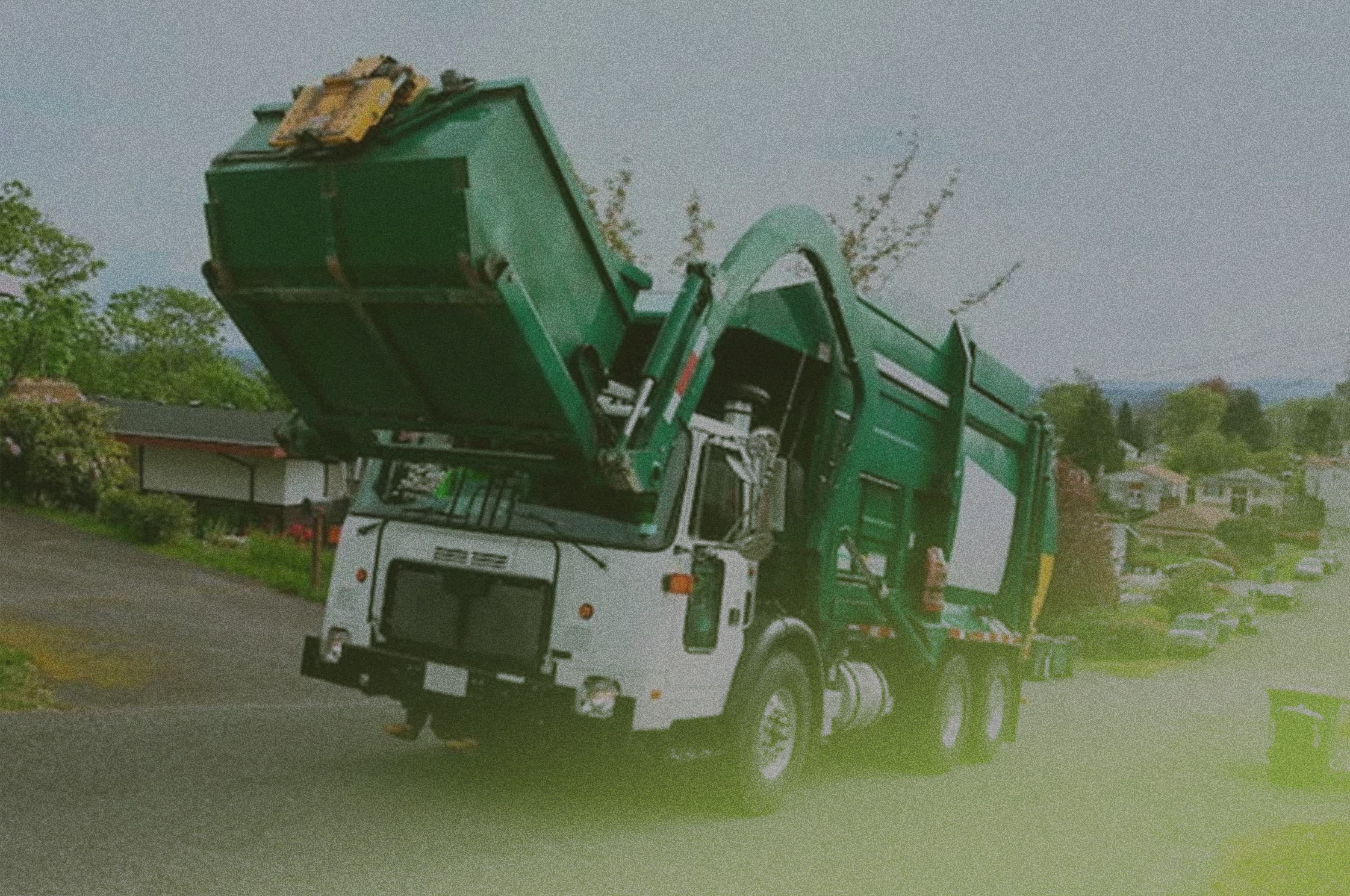 truck dropping off a roll-off container