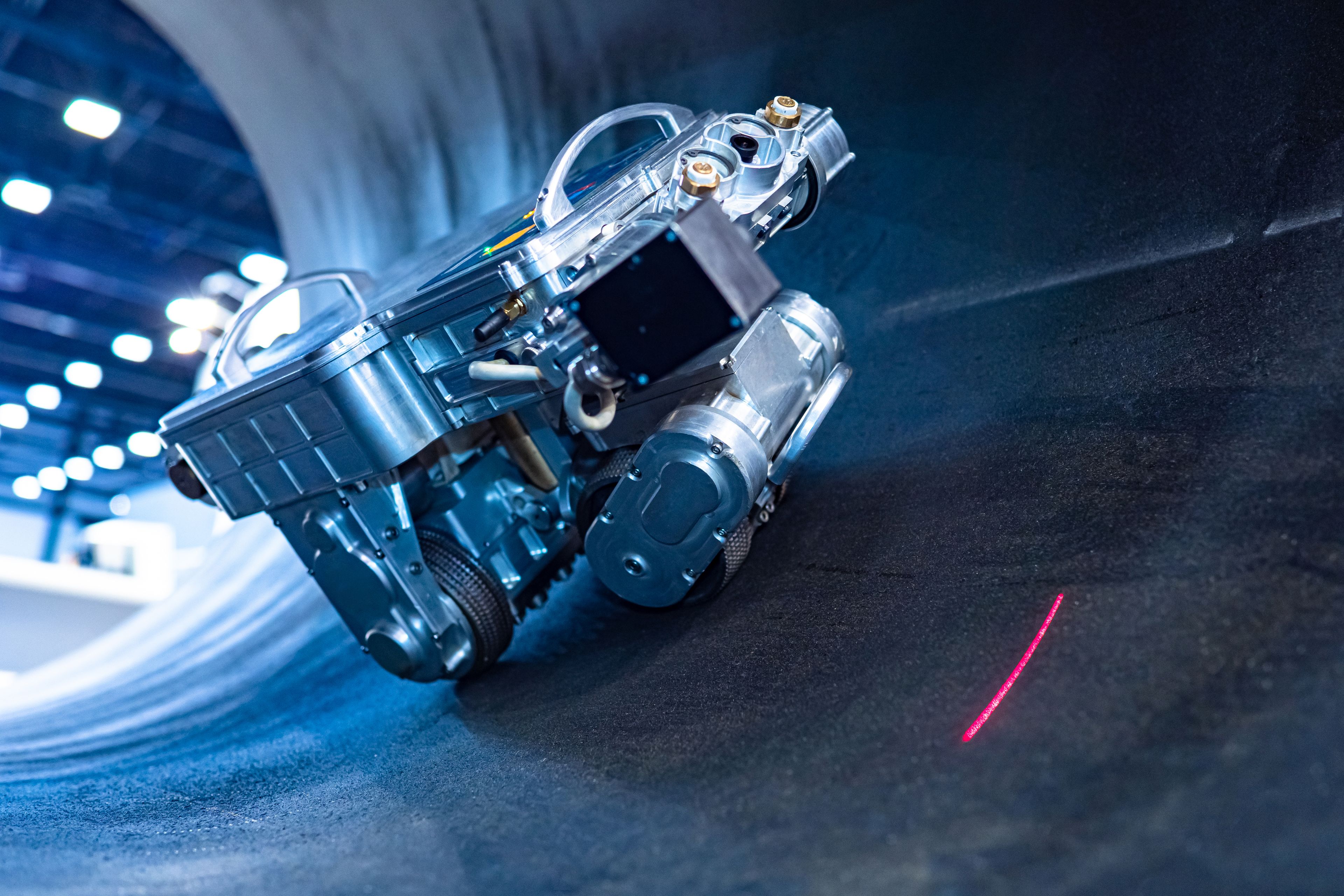 Industrial inspection robot with laser sensor moving through a pipeline