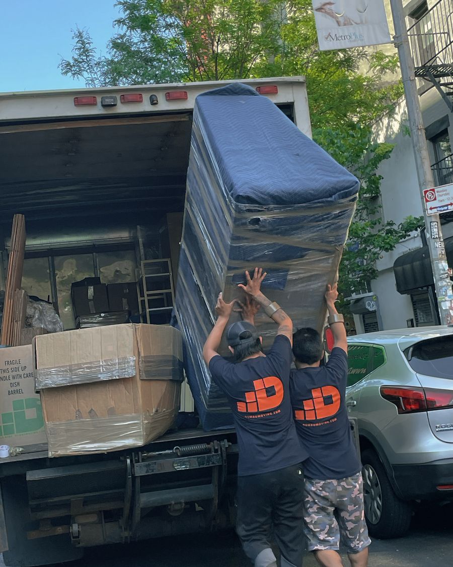 Dumbo Moving crew loading a moving truck for a New York City apartment move requiring a Certificate of Insurance (COI).