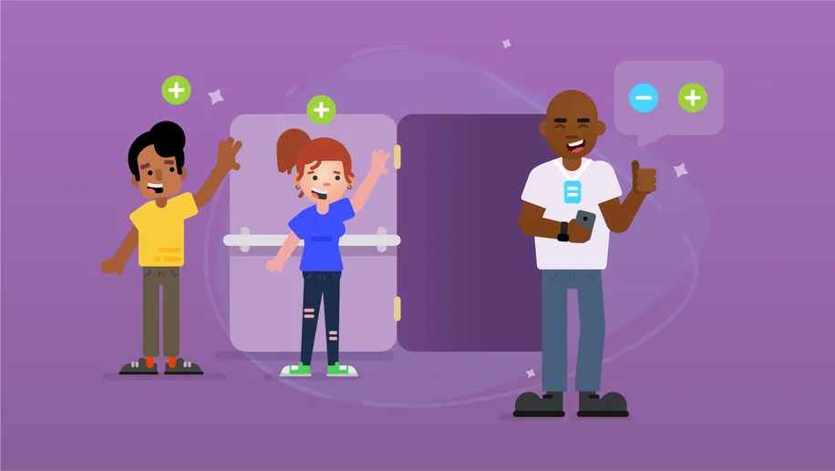 A smiling man holding a phone taking attendance of people walking through a door.