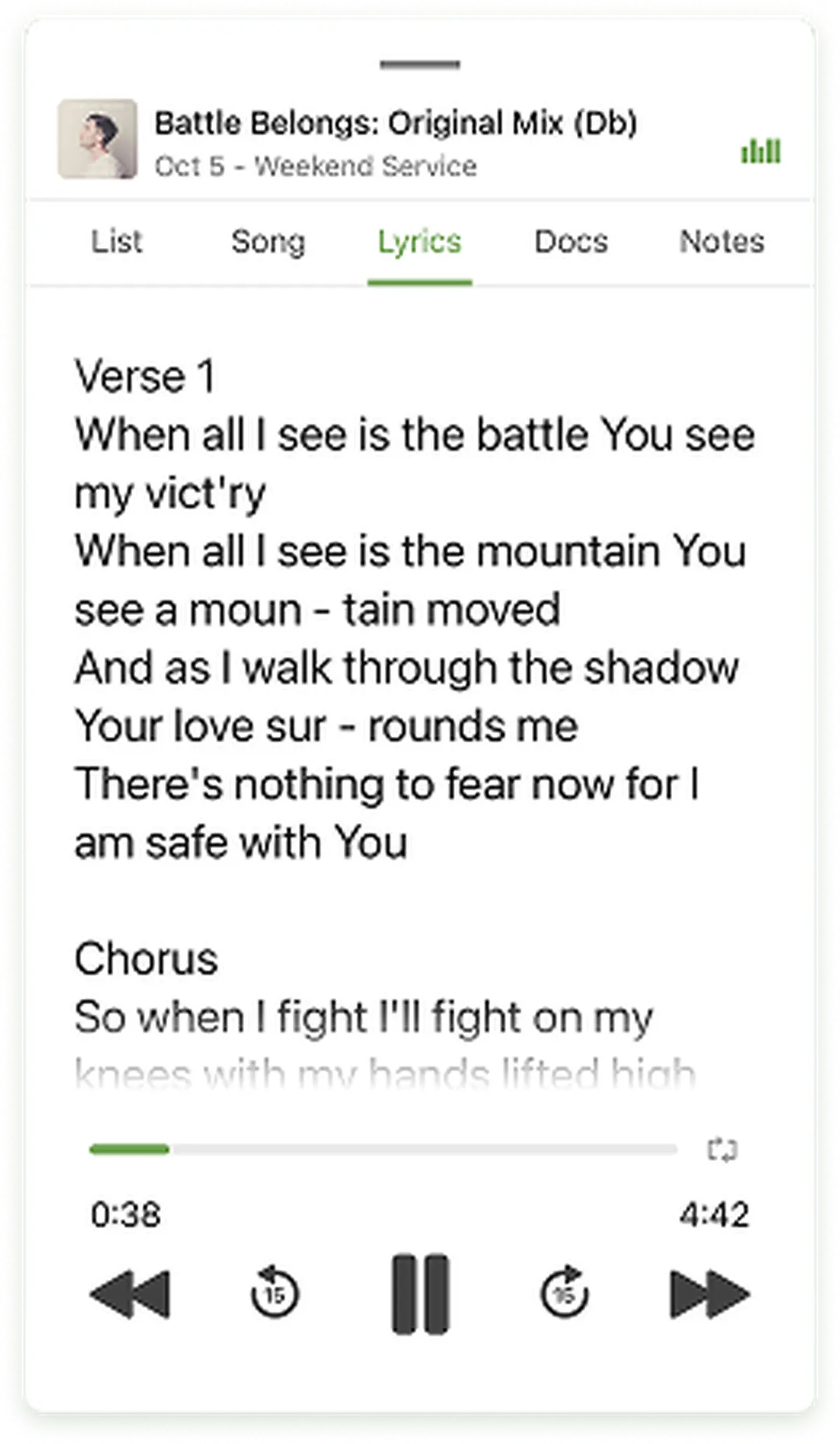 Lyrics displayed on a smartphone screen, showing a song titled "Battle Belongs." The verse and chorus are partially visible.