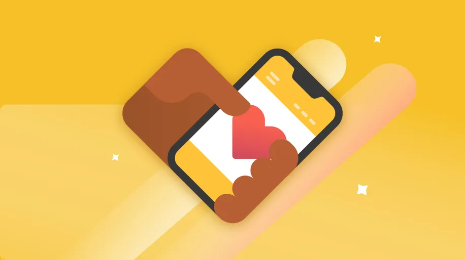 A hand holding a mobile phone with a heart in the middle of the screen.