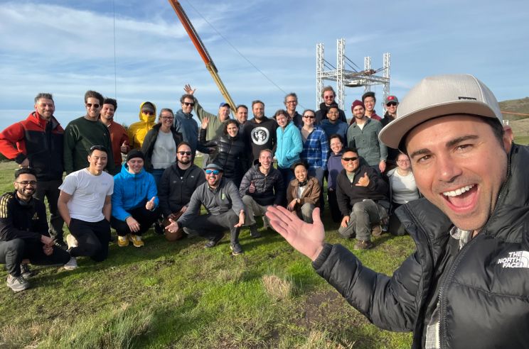 Mark Rober poses for selfie with group of Zipline team members in background