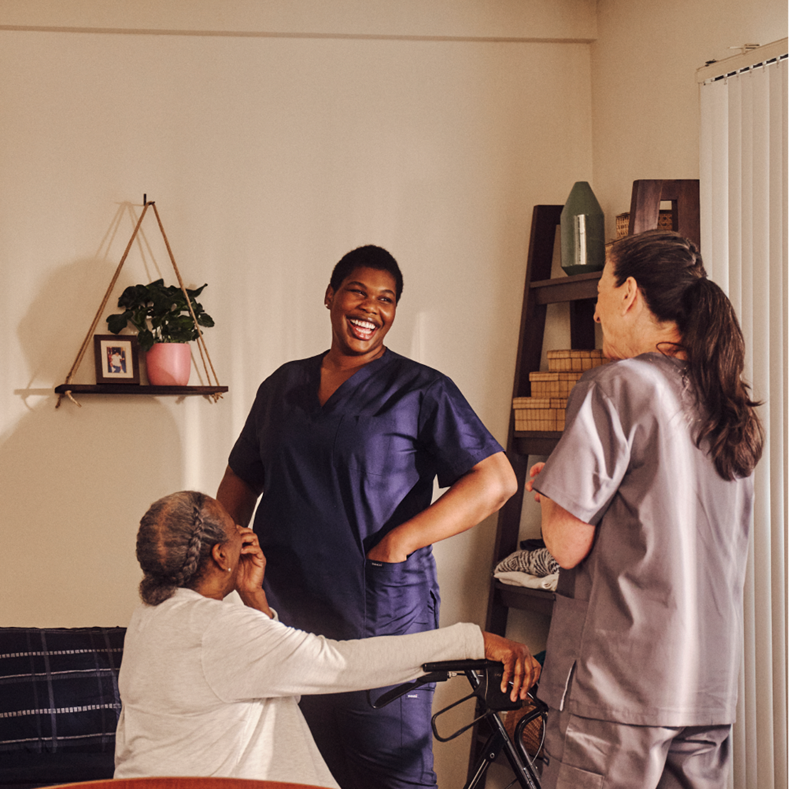 A resident and two independent professionals laughing together.