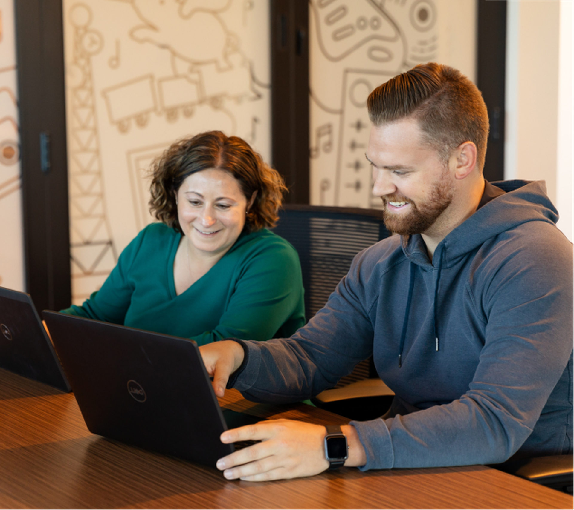 Office workers looking at laptops