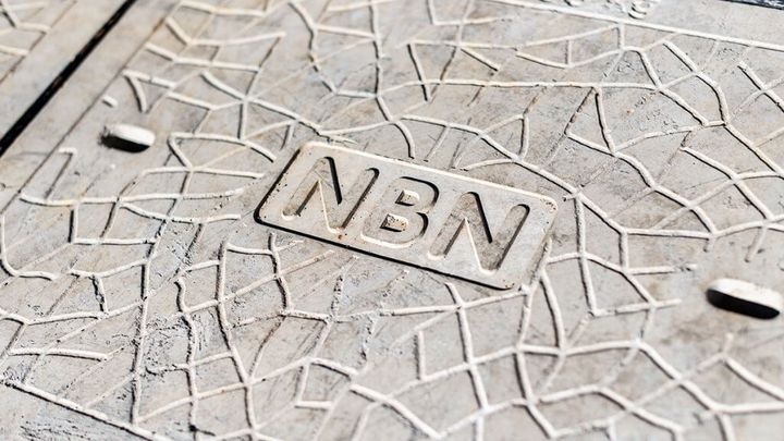 A manhole cover with the word "nbn" on it