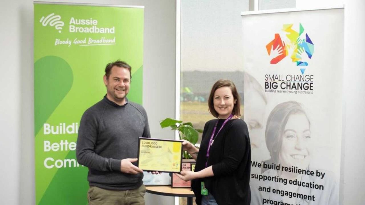 Cameron Foley, Operations Manager at Small Change Big Change presents Caroline Kennon, Community Impact Manager Aussie Broadband with our Yellow Certificate.
