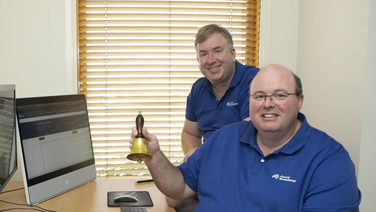 Aussie Broadband managing director Phillip Britt rings a bell to signal the company's debut on the ASX