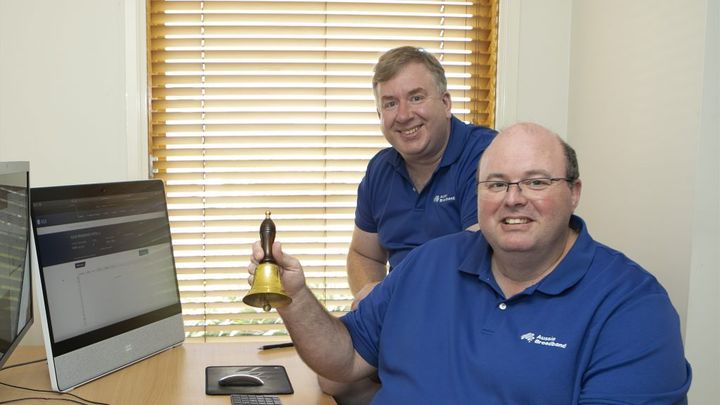 Aussie Broadband managing director Phillip Britt rings a bell to signal the company's debut on the ASX