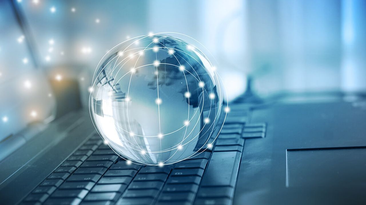 A globe on a laptop keyboard. Covering the globe is an illustration of a network with several illuminated dots connected to each other by various lines. These dots are also present in the space between the globe and the laptop screen.