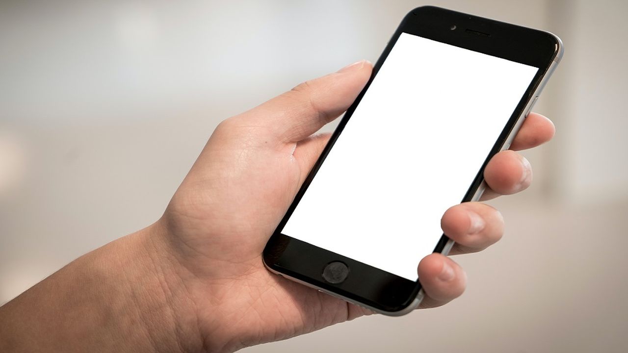 Photo of a hand holding a smartphone