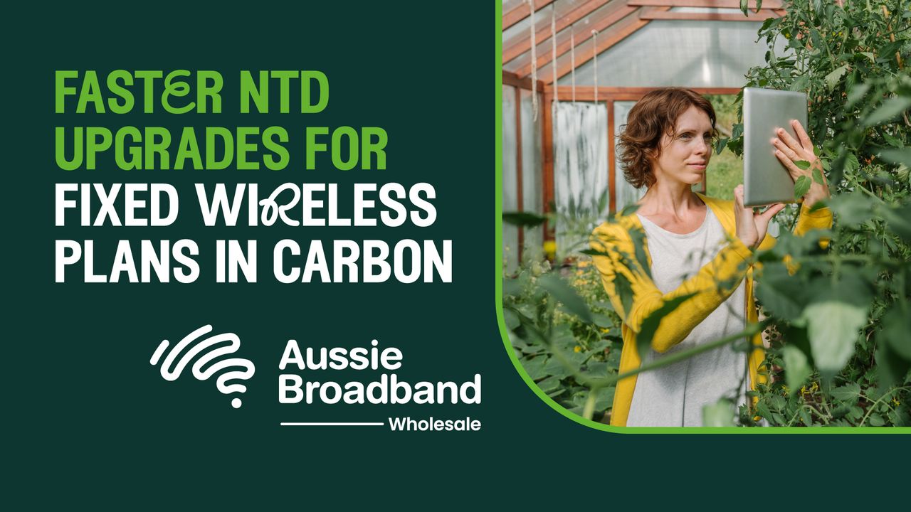Faster NTD Upgrades for Fixed Wireless Plans in Carbon banner from Aussie Broadband Wholesale with photo of a woman holding up and interacting with a tablet device in a greenhouse.