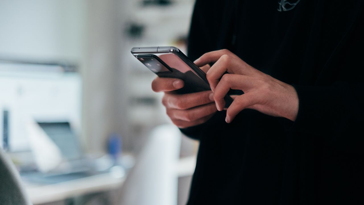 Stock photo of a person holding a smartphone