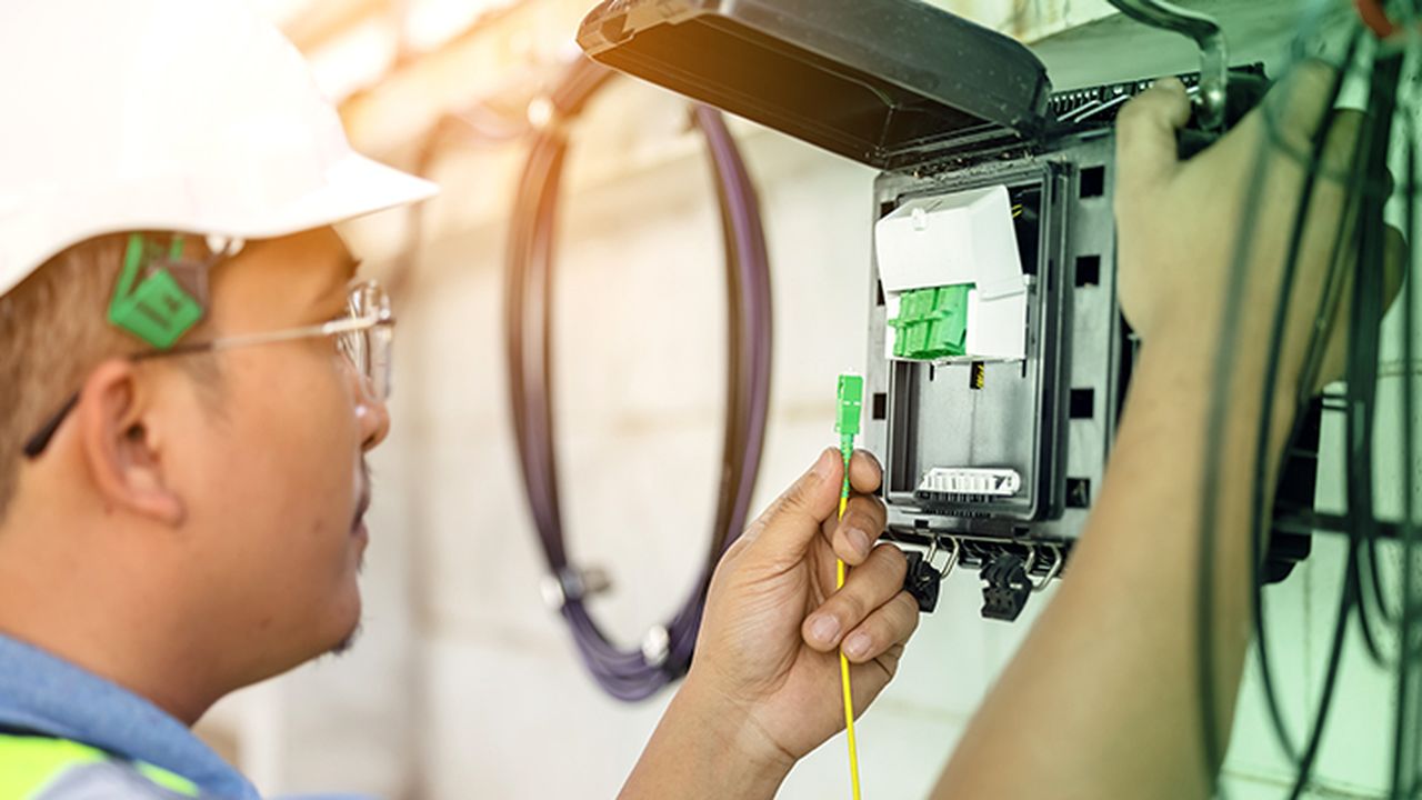Technician upgrading an outdoor fibre box