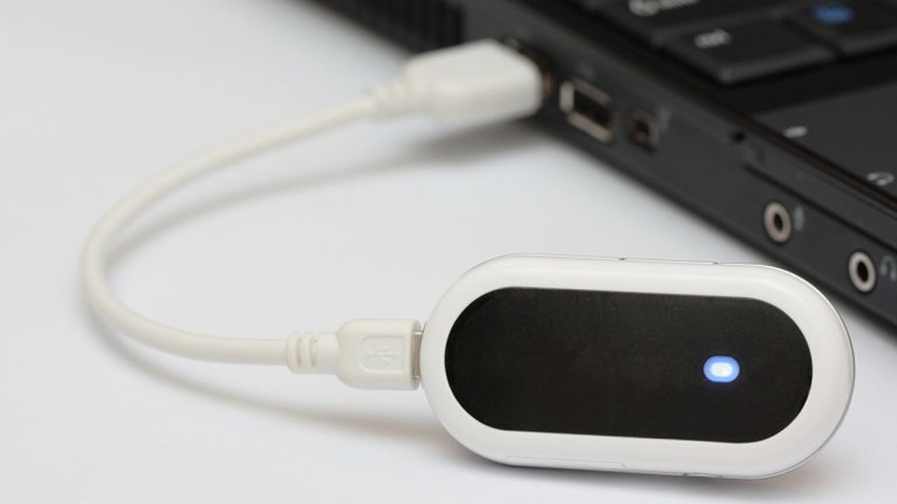 A mobile broadband dongle connected to a laptop