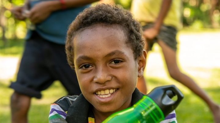A child with a green Aussie Broadband water bottle