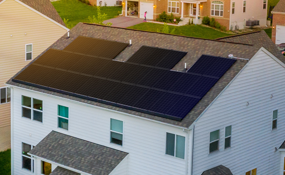 A solar farm with mountains in the background