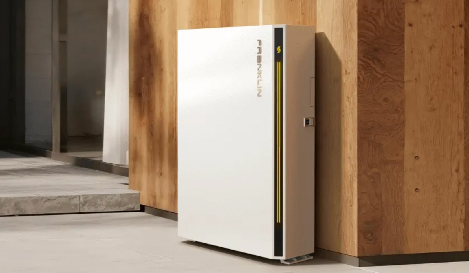 Sleek white rectangular device with a vertical yellow line against a wooden wall in a modern interior space.