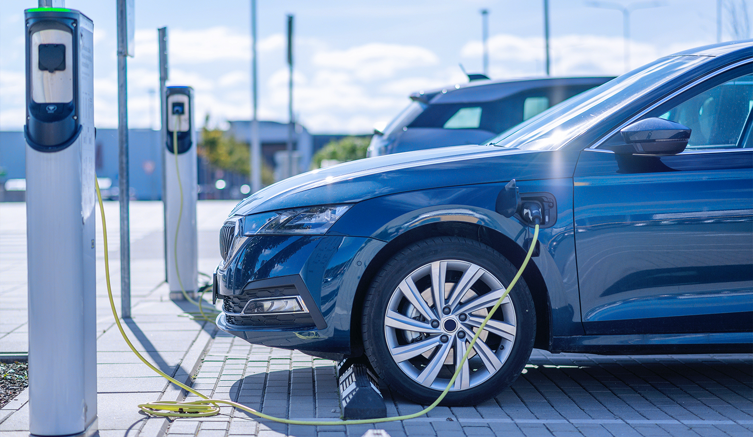 EV car charging at a public charging station.