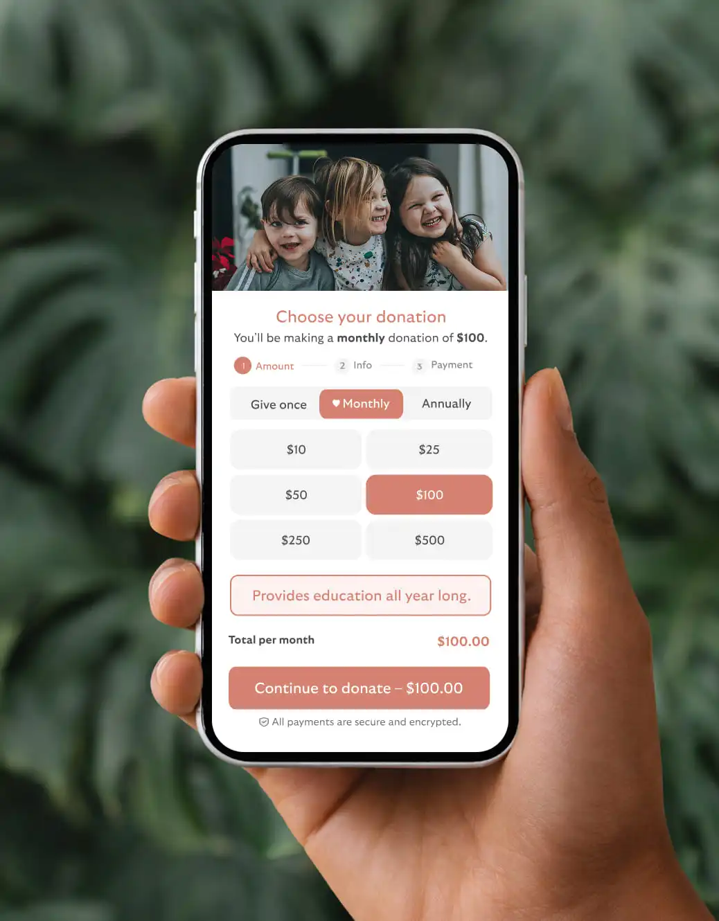 Hand holding phone showing a BetterWorld donation form with kids photo