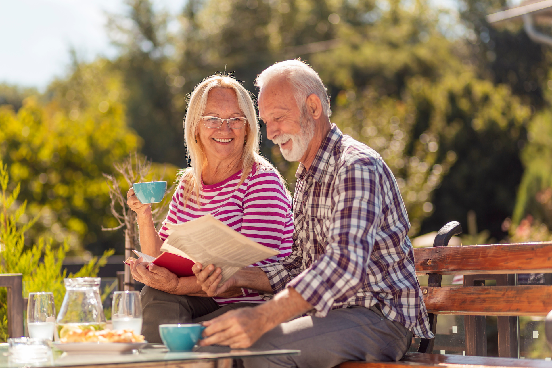 older-adult-couple-drinking-and-eating-on-porch