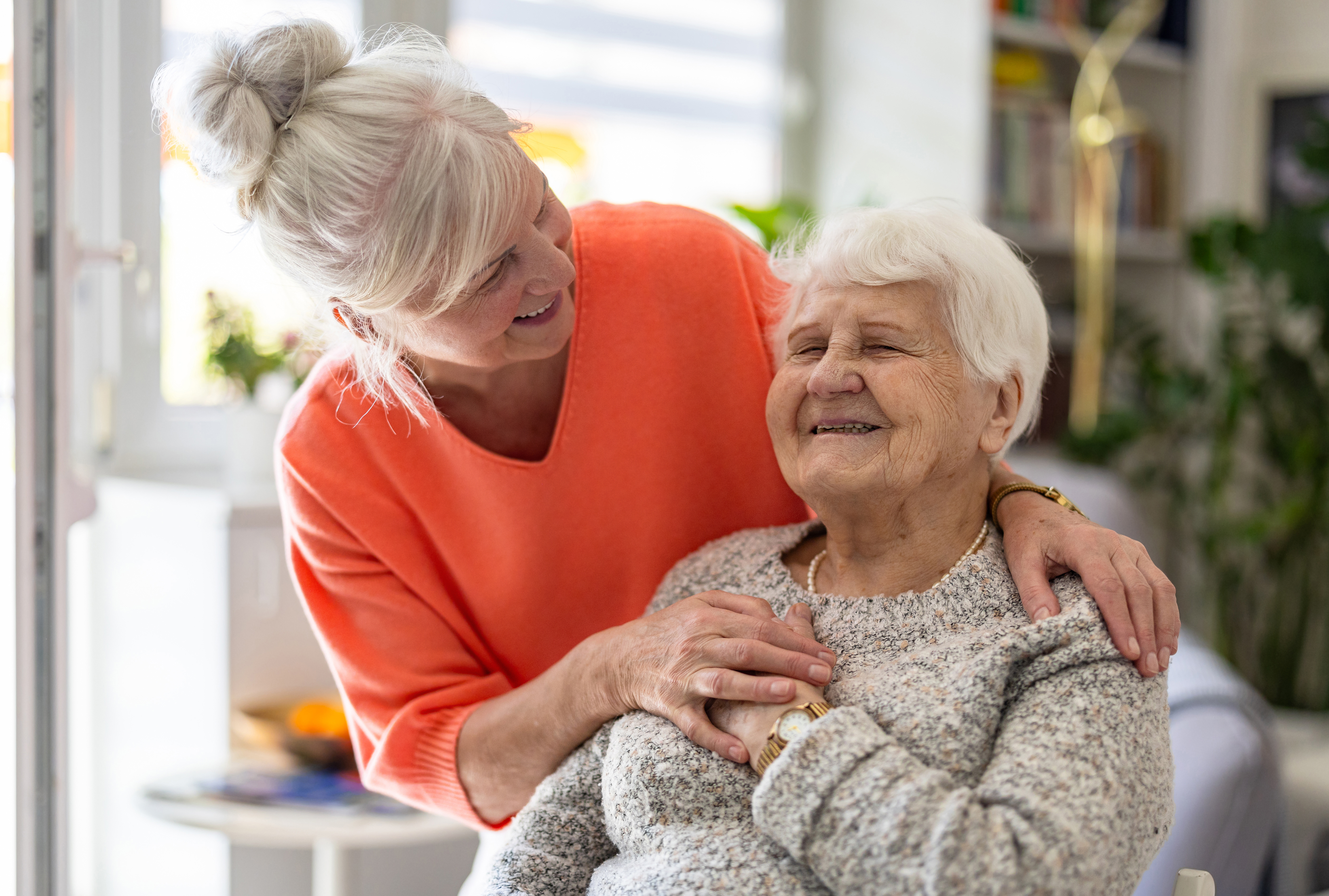 caregiver-embracing-older-adult
