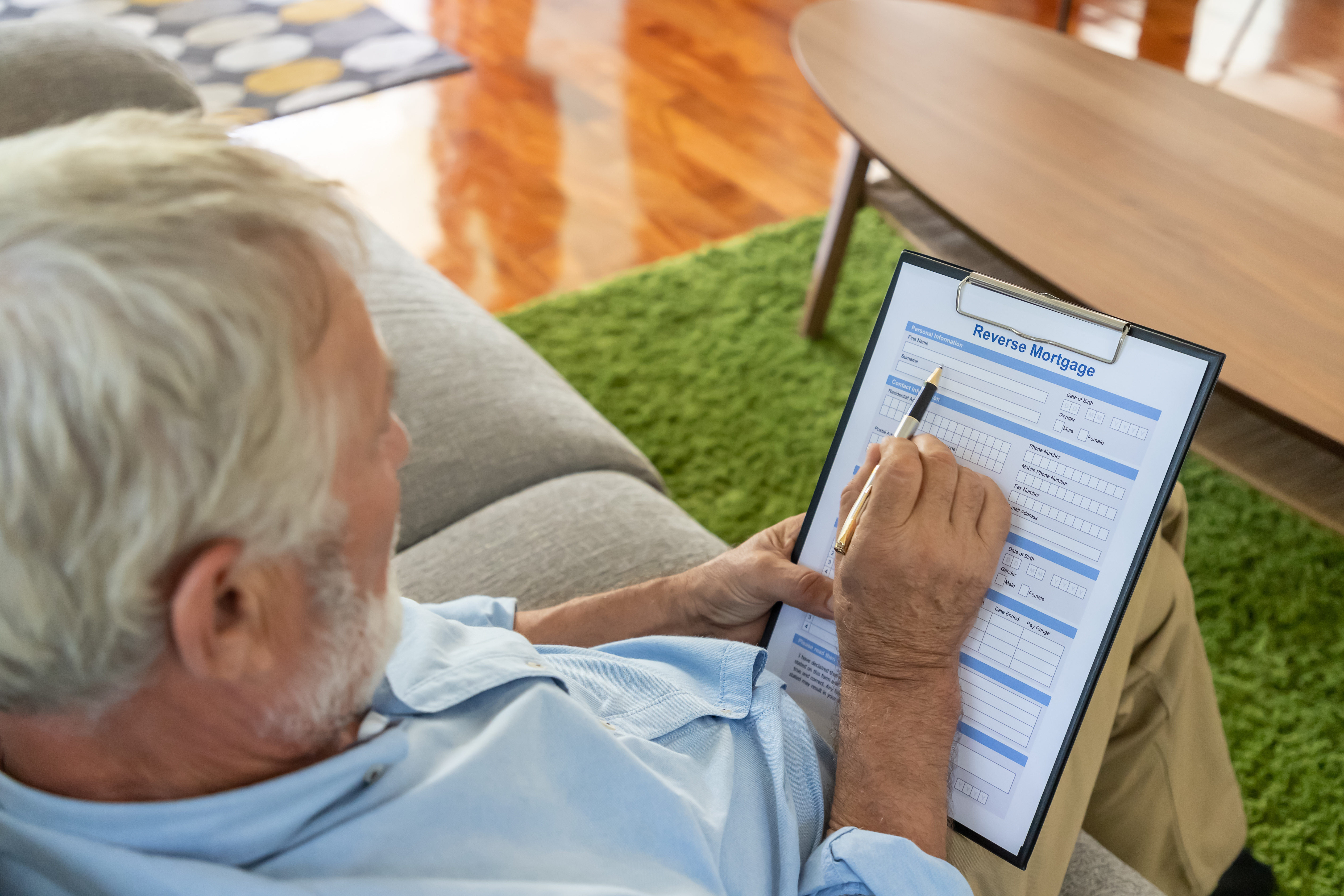 older-adult-looking-at-reverse-mortgage-application