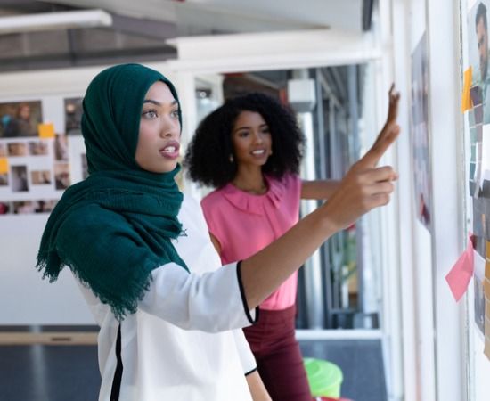 Two women discussing a project a work.