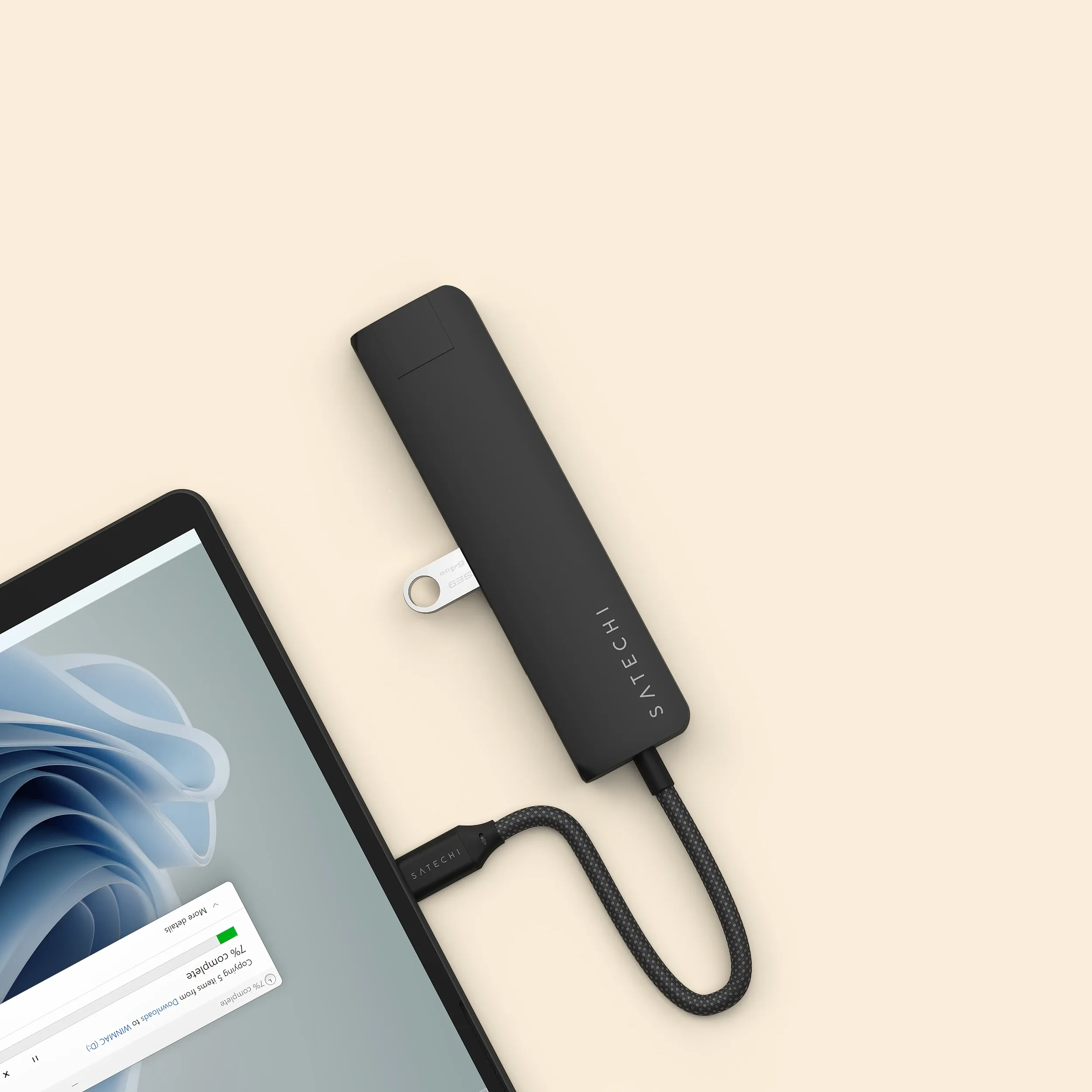Satechi 7-in-1 USB-C Slim Multiport Adapter with Ethernet transferring files onto an iPad.