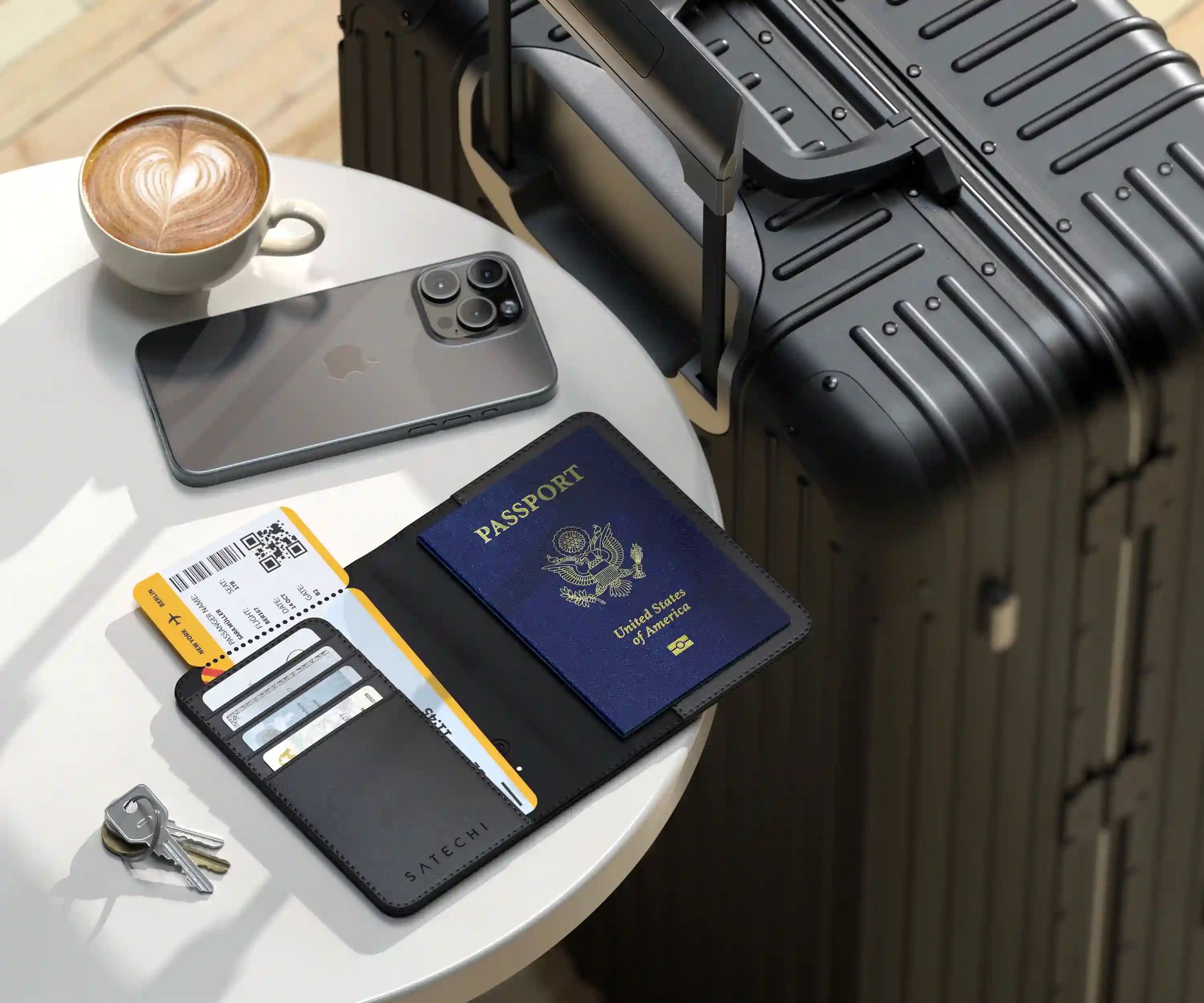Satechi FindAll™ Passport Cover on desk with iphone and luggage