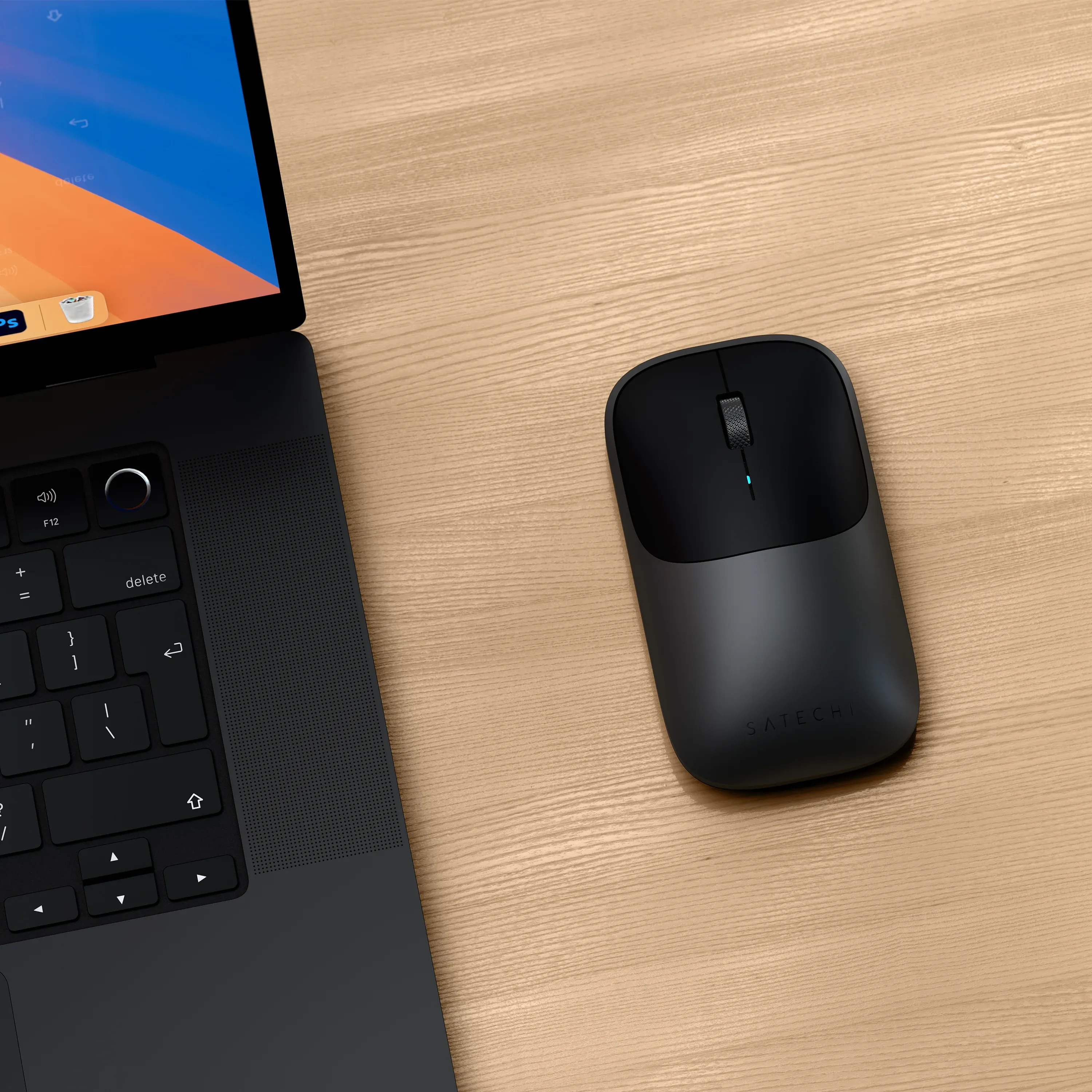 A Satechi Slim EX Wireless Mouse connected to a MAcBook.