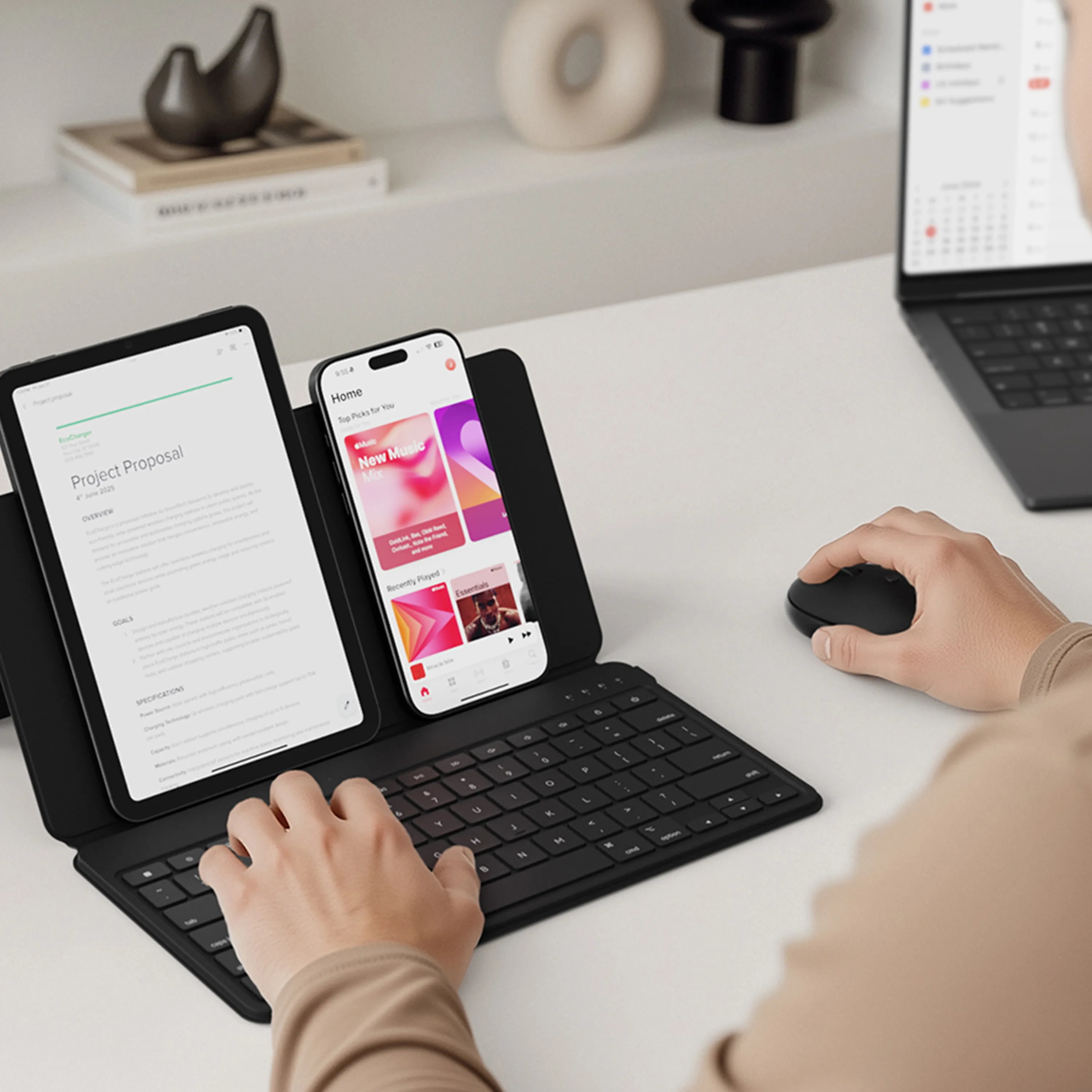 A person using their tablet and iPhone with the Satechi OntheGo™ Bluetooth Keyboard with Stand and Bluetooth Mouse.