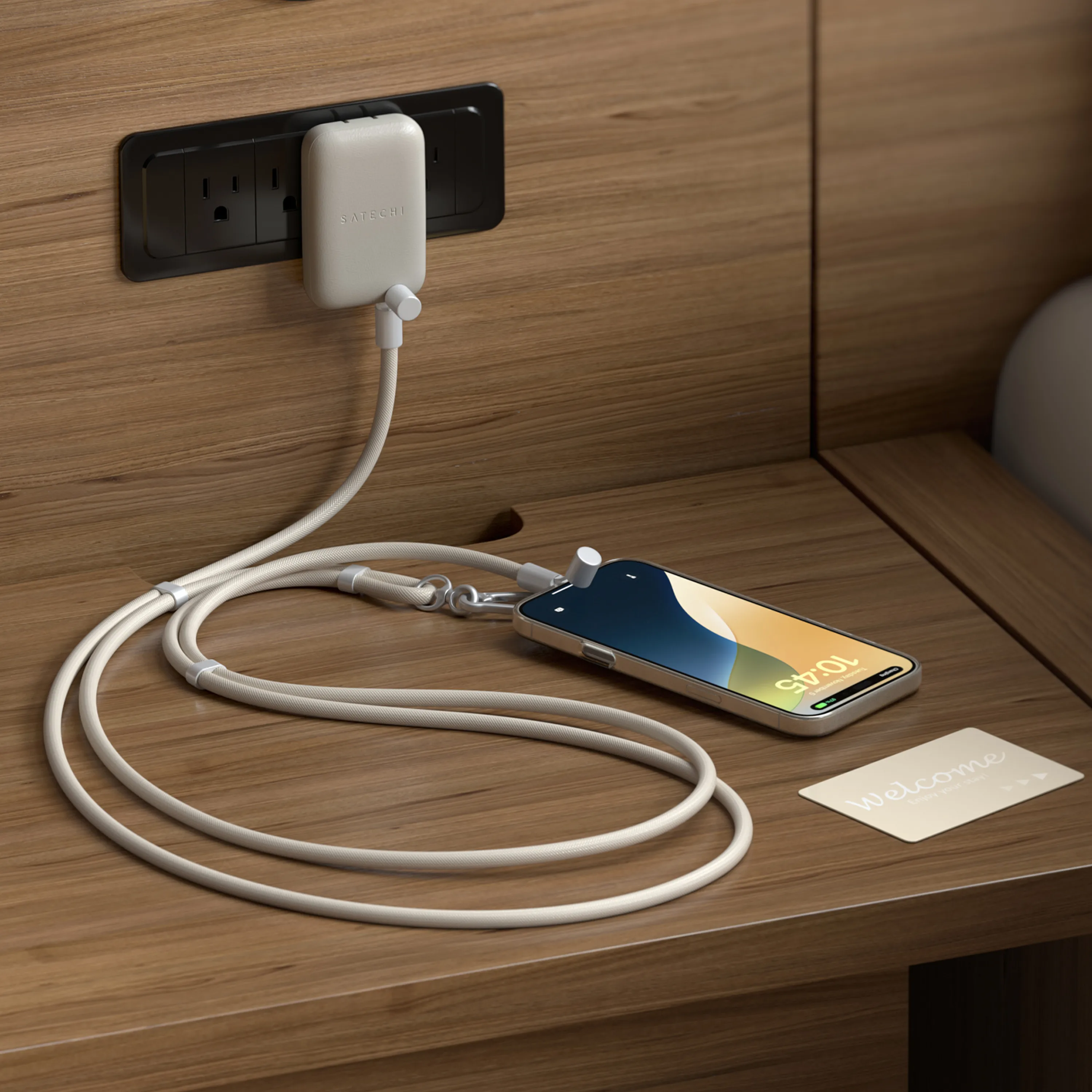 A OntheGo™ USB-C Lanyard Cable connected to a OntheGo 67W SLim Charger on a bedside table.