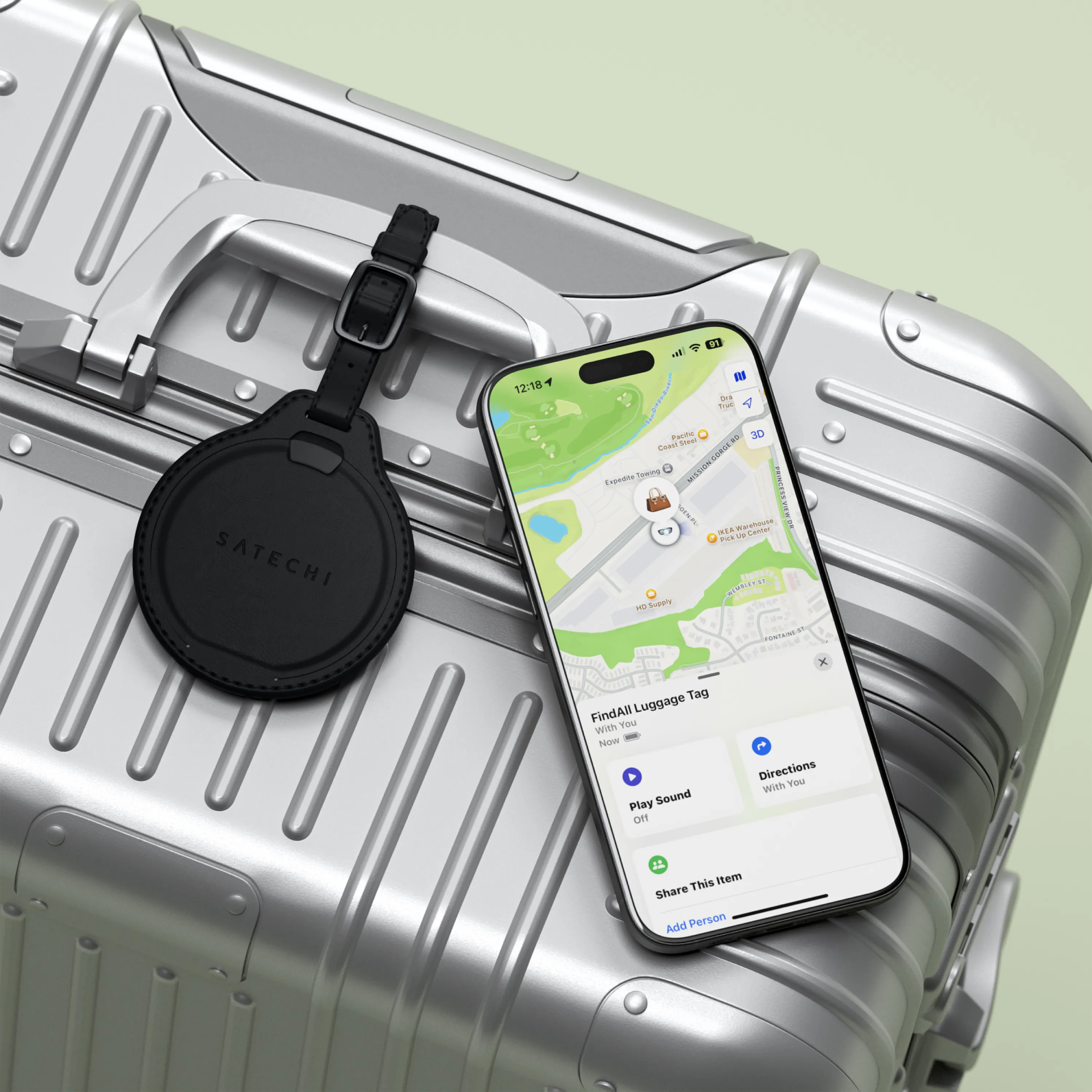 Satechi FindAll™ Luggage Tag attached to suitcase, with iPhone actively tracking its location.