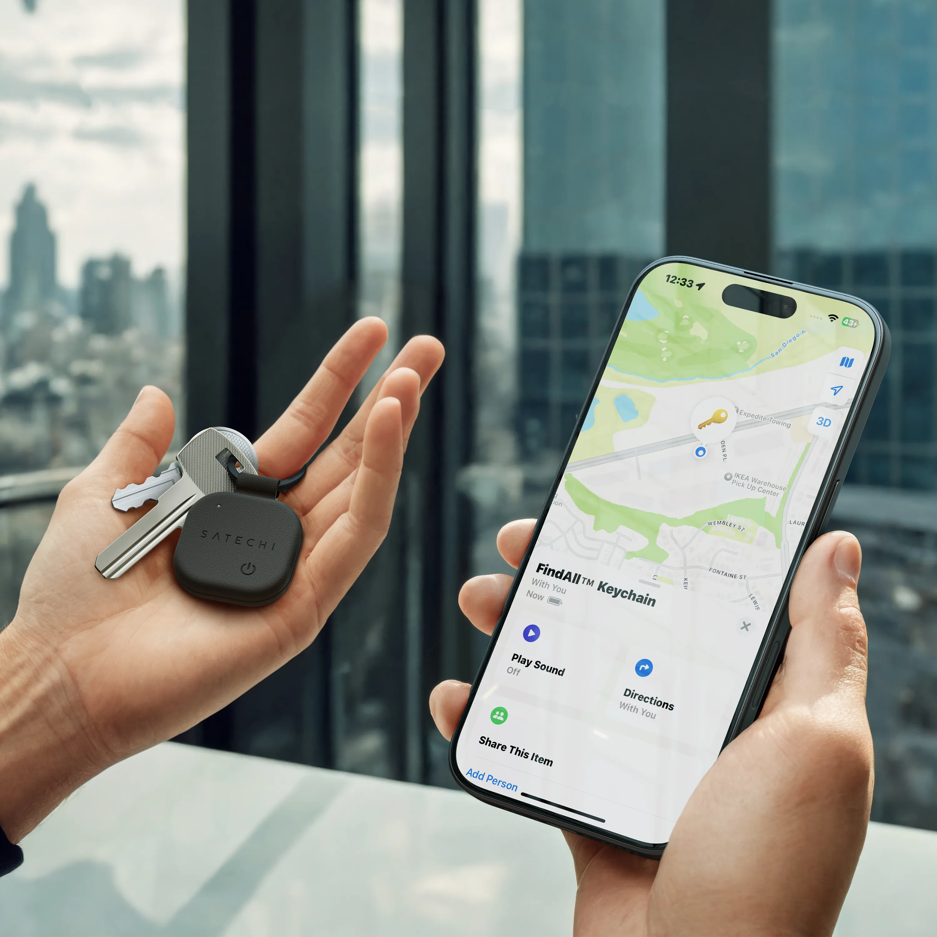 Hands holding FindAll™ Keychain and keys