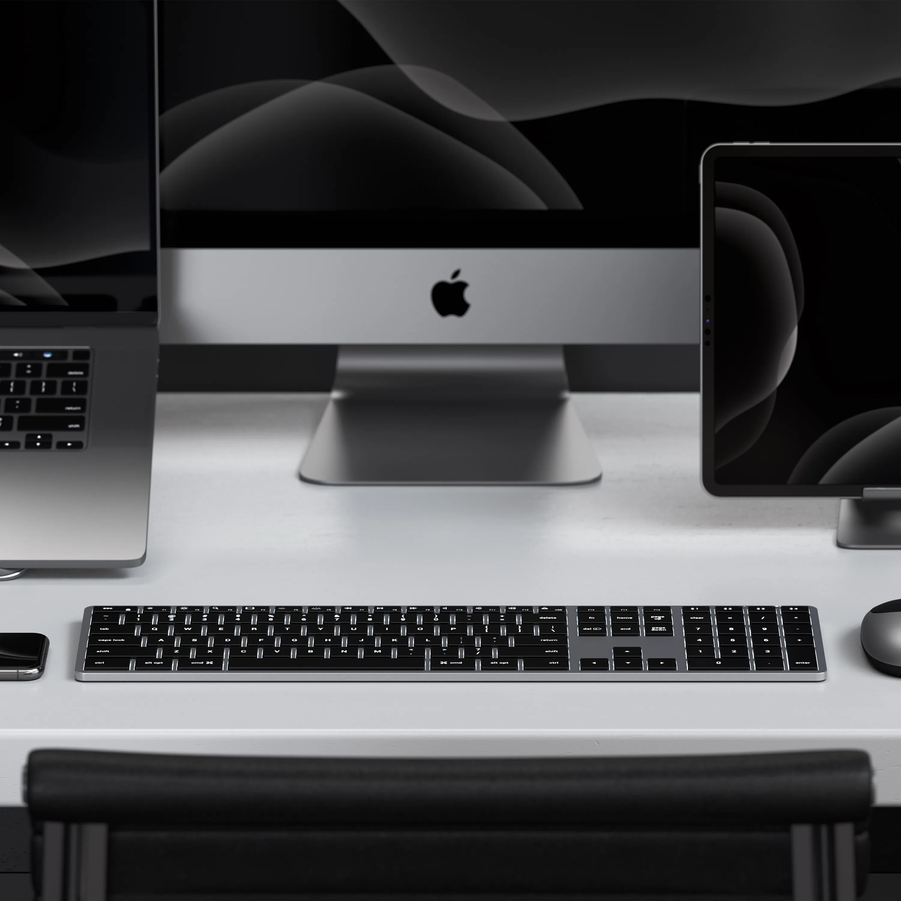 A Satechi Slim X3 Bluetooth Backlit Keyboard paired to a MacBook, iMac, and iPad.