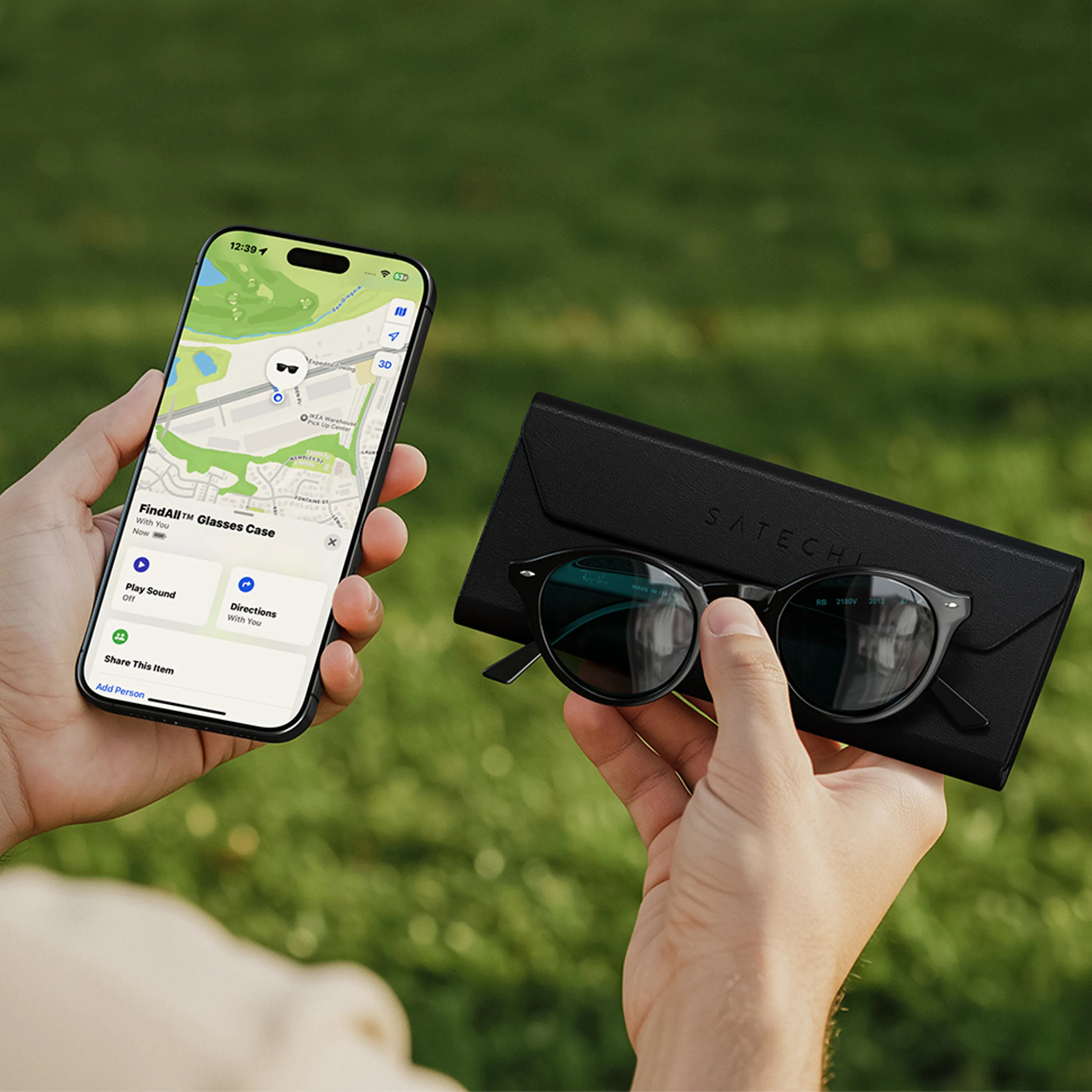 A person holding a Vegan-Leather FindAll™ Glasses Case with a pair of sunglasses in one hand and in the second hand is an iPhone displaying a FindMy app open. The Vegan-Leather FindAll™ Glasses Case is being tracked by app.
