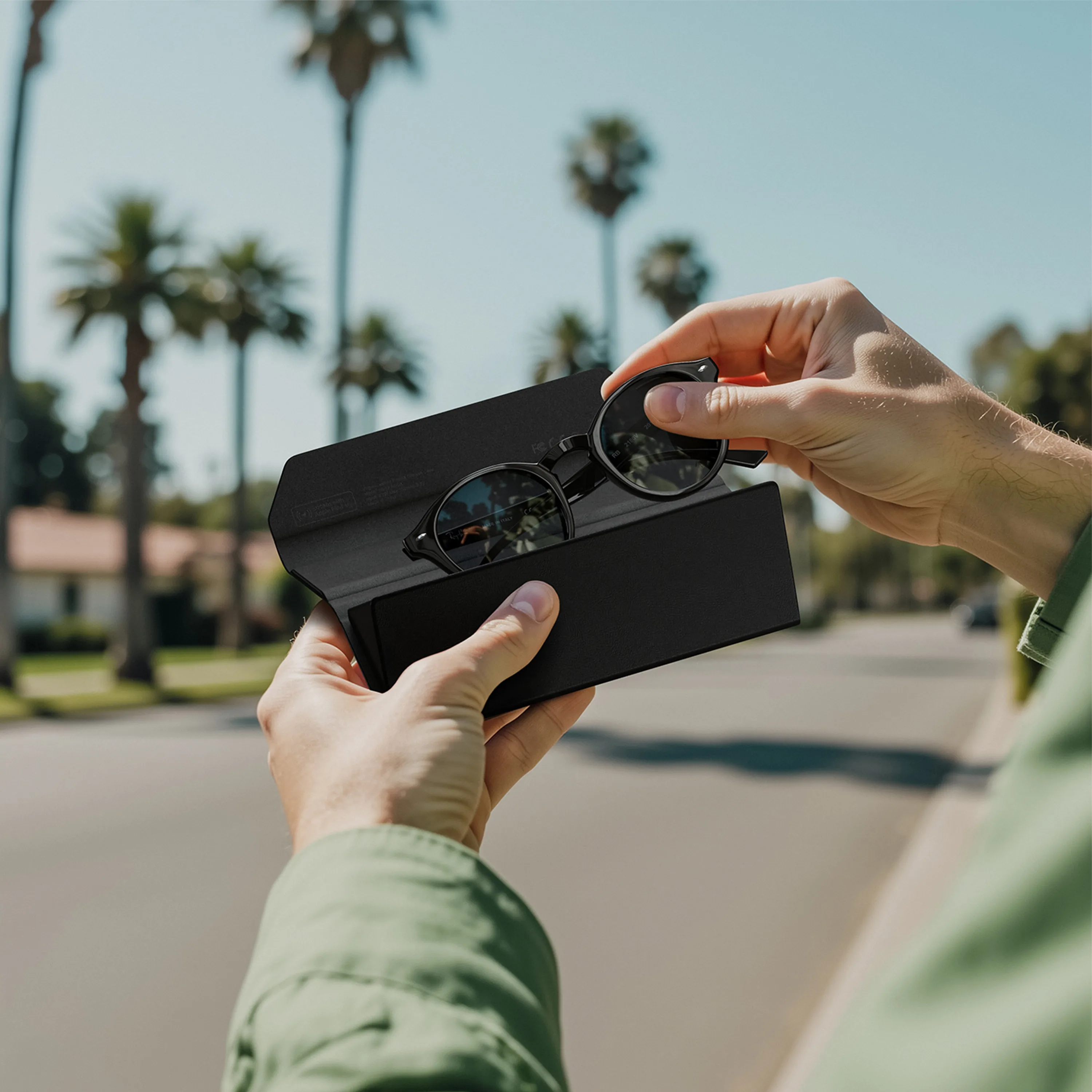 Hands holding Satechi FindAll™ Glasses Case with sunglasses