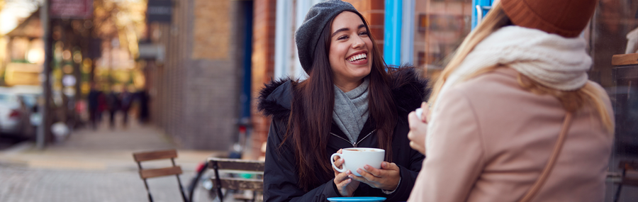 Two young women having coffee together at a cafè