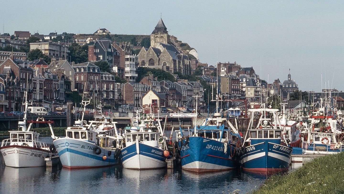 Blue and white boats docked in the harbor of Le Tréport, Normandy