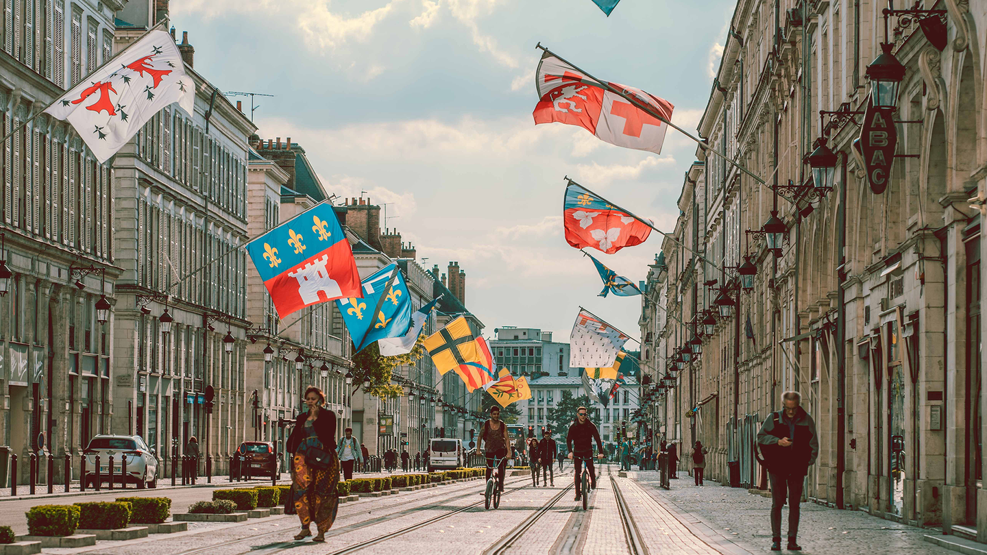 Busy street with bicycles and cars in the city centre of the city of Orléans, France