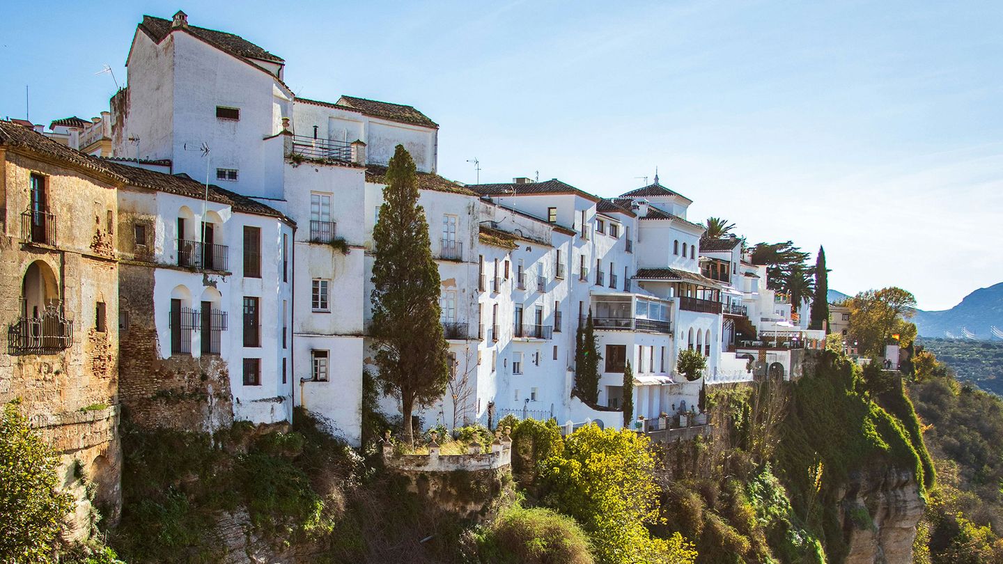 White concrete buildings next to a cliff