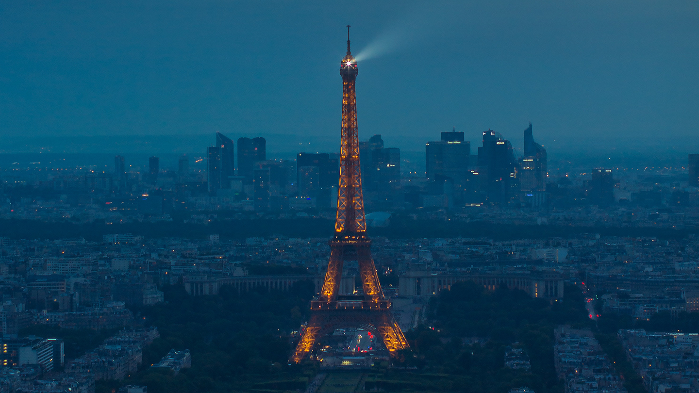 Aerial view of the Eiffel Tower lit up at night