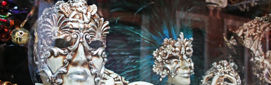 Carnival masks on display in Venice. Typical Carnival masks, which are white and ornate with feathers