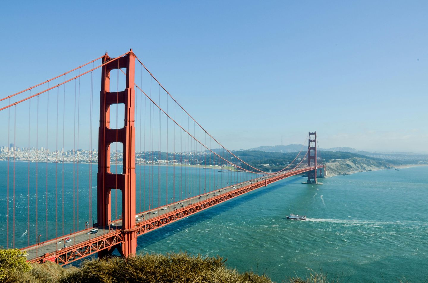 The iconic Golden Gate Bridge (a suspension bridge with two pillars) in the San Francisco bay, California