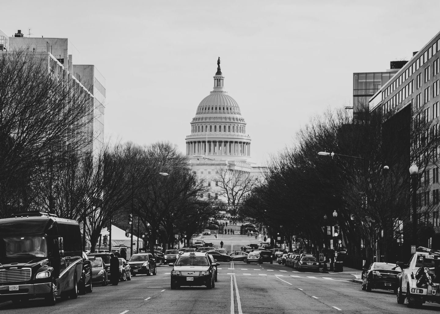 A black and white photo of Capitol Hill (a classical looking building with a dome structure in the center) in Washington DC