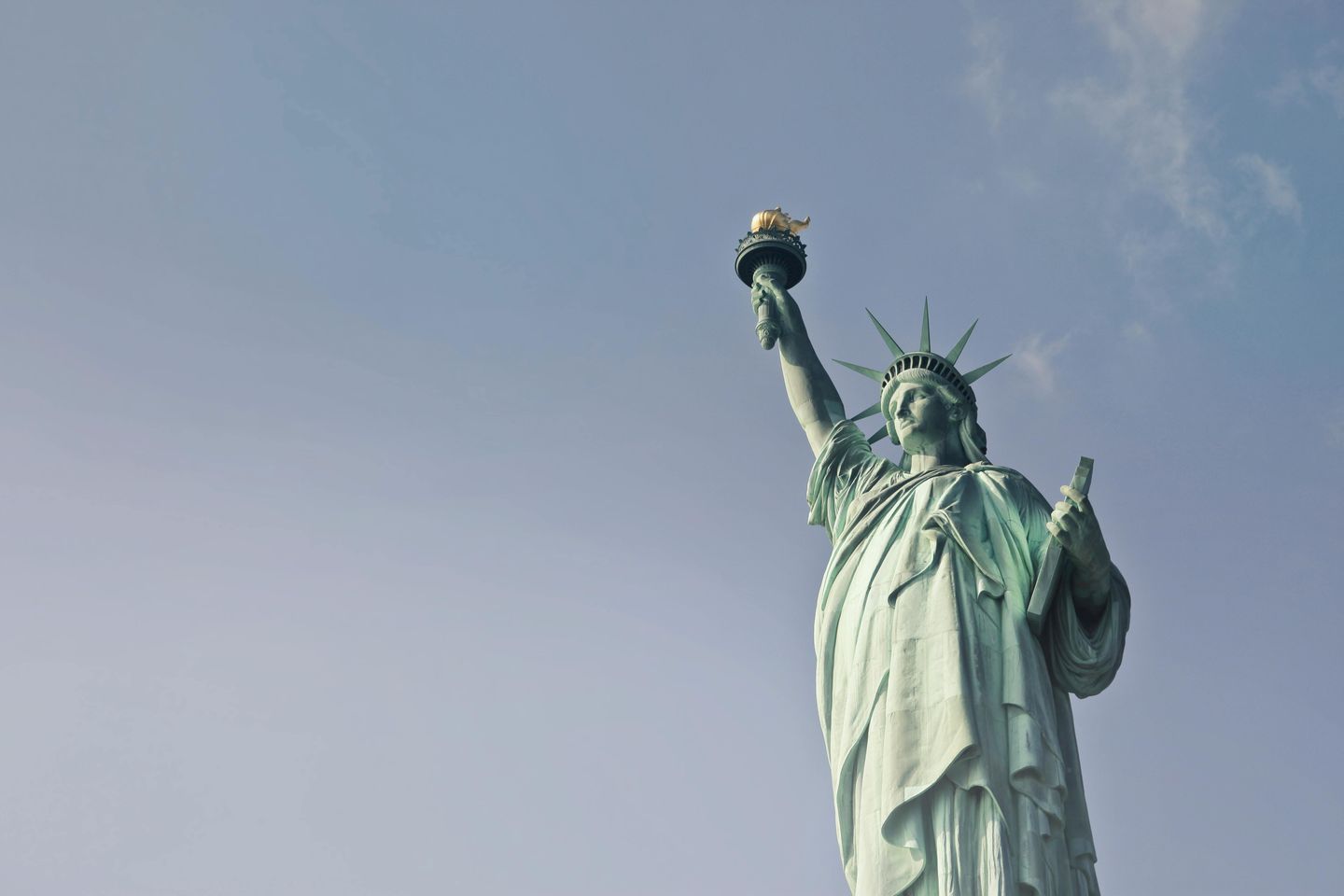 The Statue of Liberty (a woman dressed in a Roman toga carrying a torch)