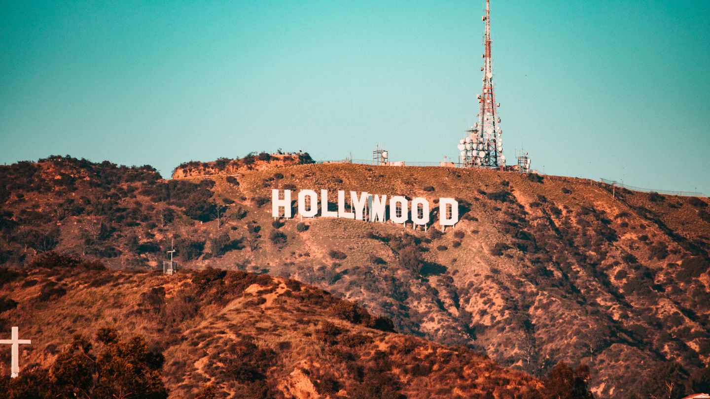 Arid hill sporting the famous Hollywood sign, a large sign made of big white letters spelling the word Hollywood