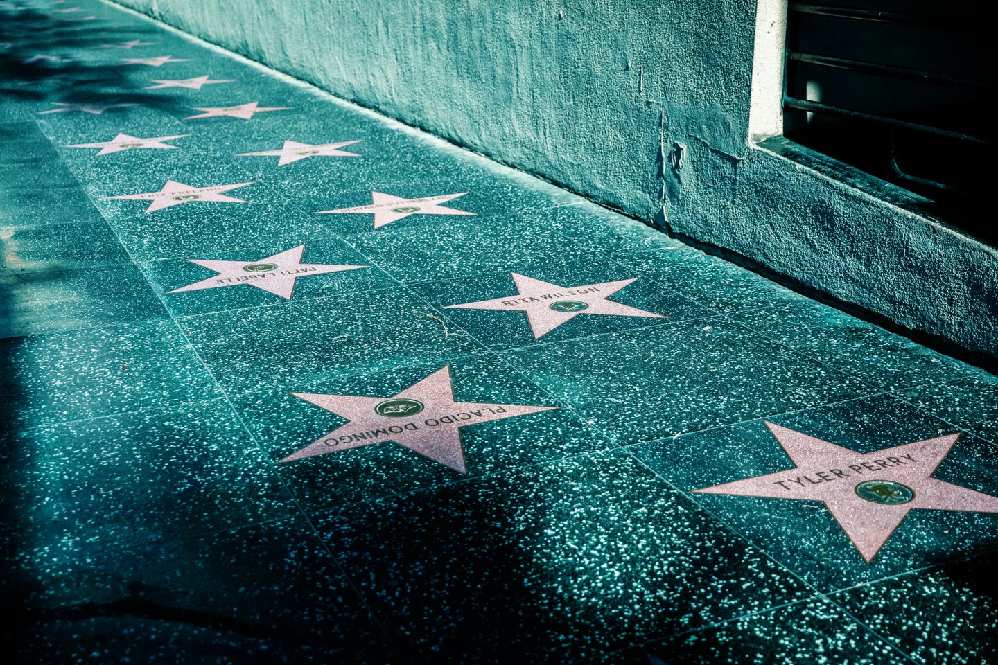 The Hollywood walk of fame, a paved street with stars on the tiles that contain the names of famous actors, singers, entertainers, and more in California