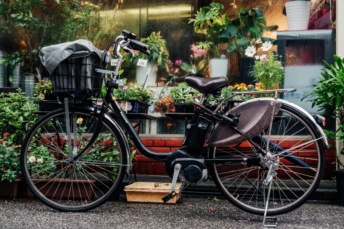 A bicycle at a Japanese flower shop